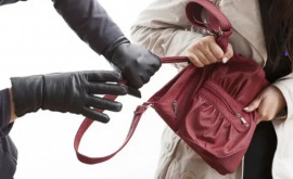 Momentul în care un individ fură telefonul mobil din geanta unei femei în capitală