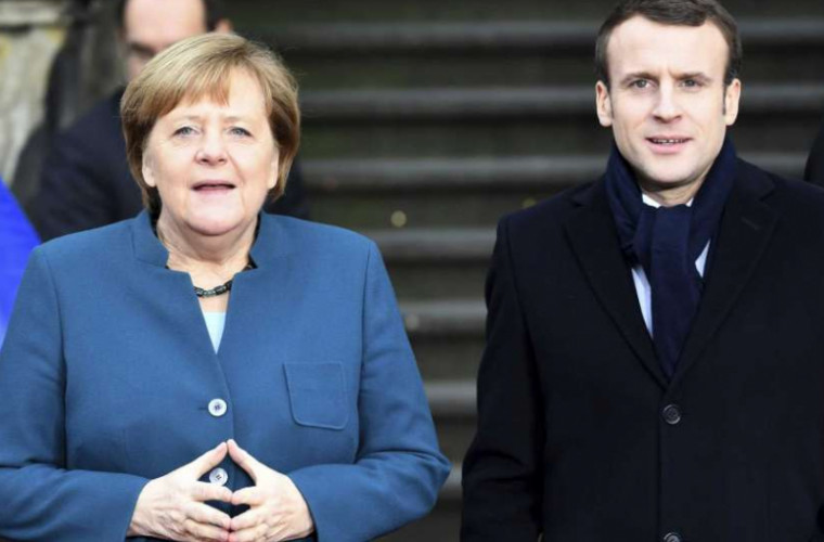 Merkel și Macron, huiduiți de protestatari în Germania